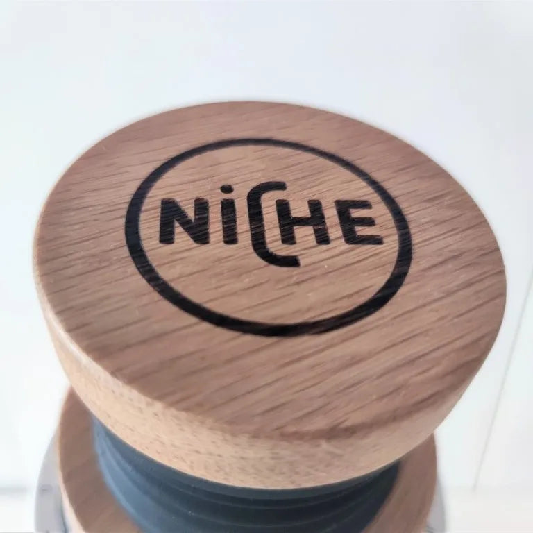 Close-up of a Niche-branded white oak lid for the Niche Zero bellows kit